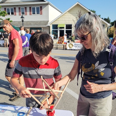 child and adult building at STEM event