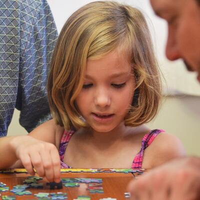 Child putting together a puzzle